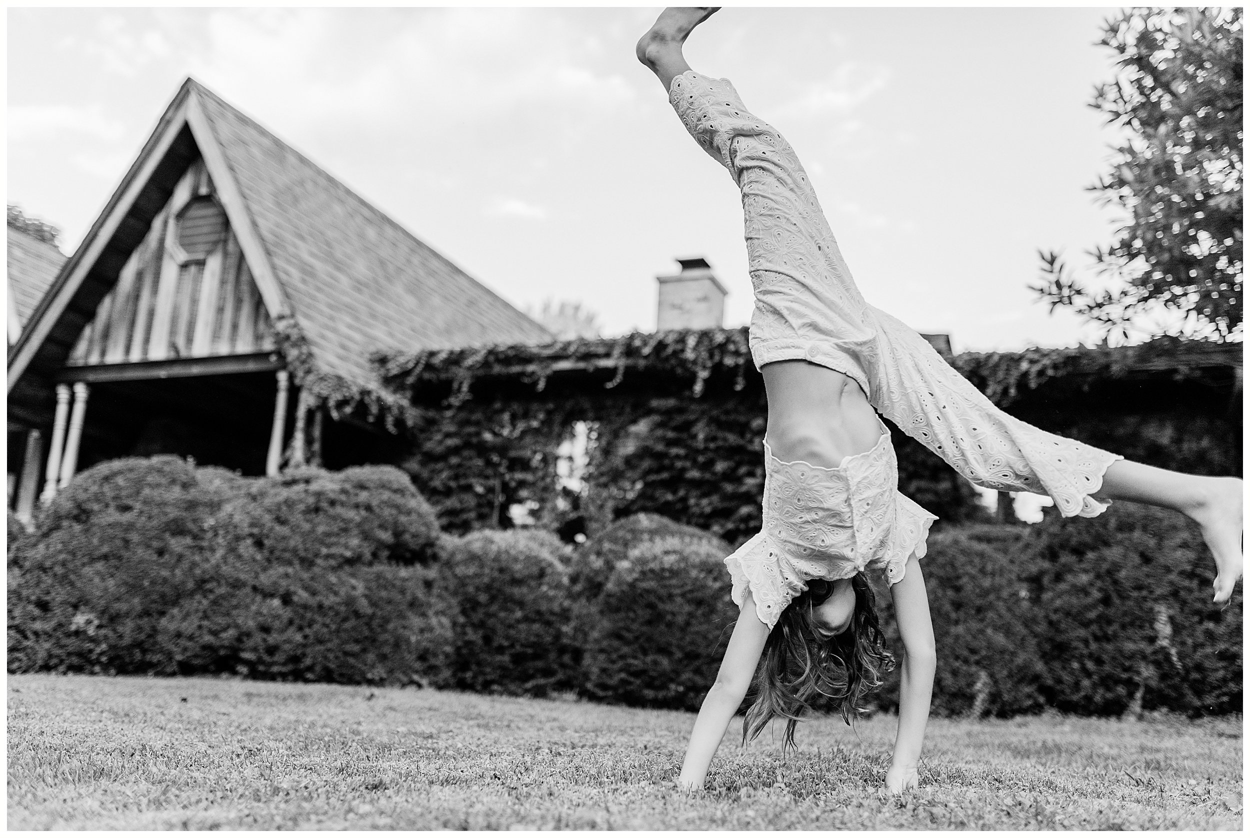  girl doing cartwheel in front of home in fun family photos in Lexington KY 