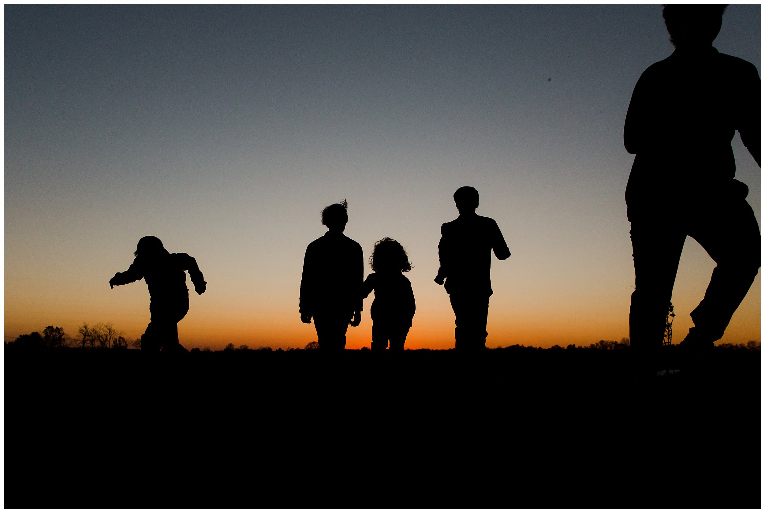  sunset silhouette family running lifestyle family photo session Richmond KY 