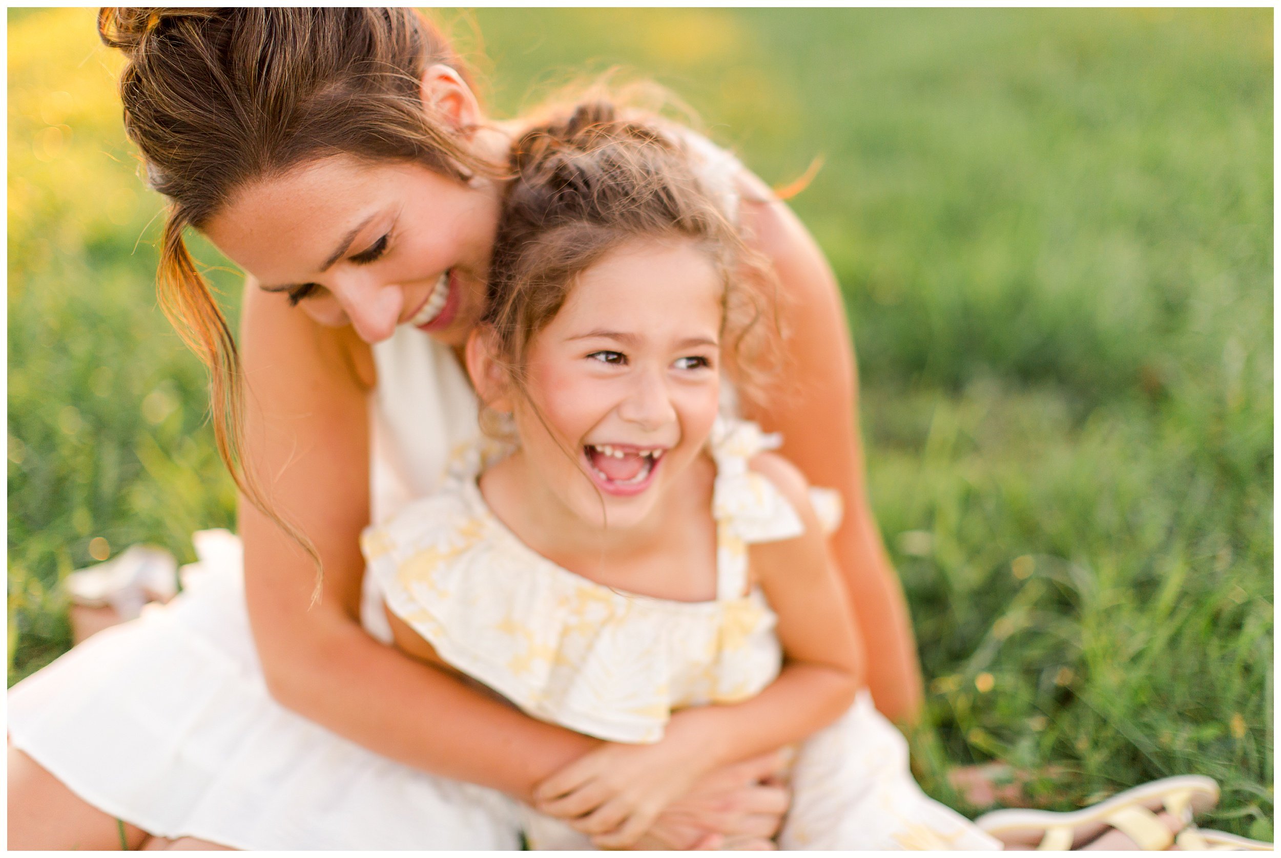  mom daughter laughing snuggled in field at sunset in fun family photography Lexington 