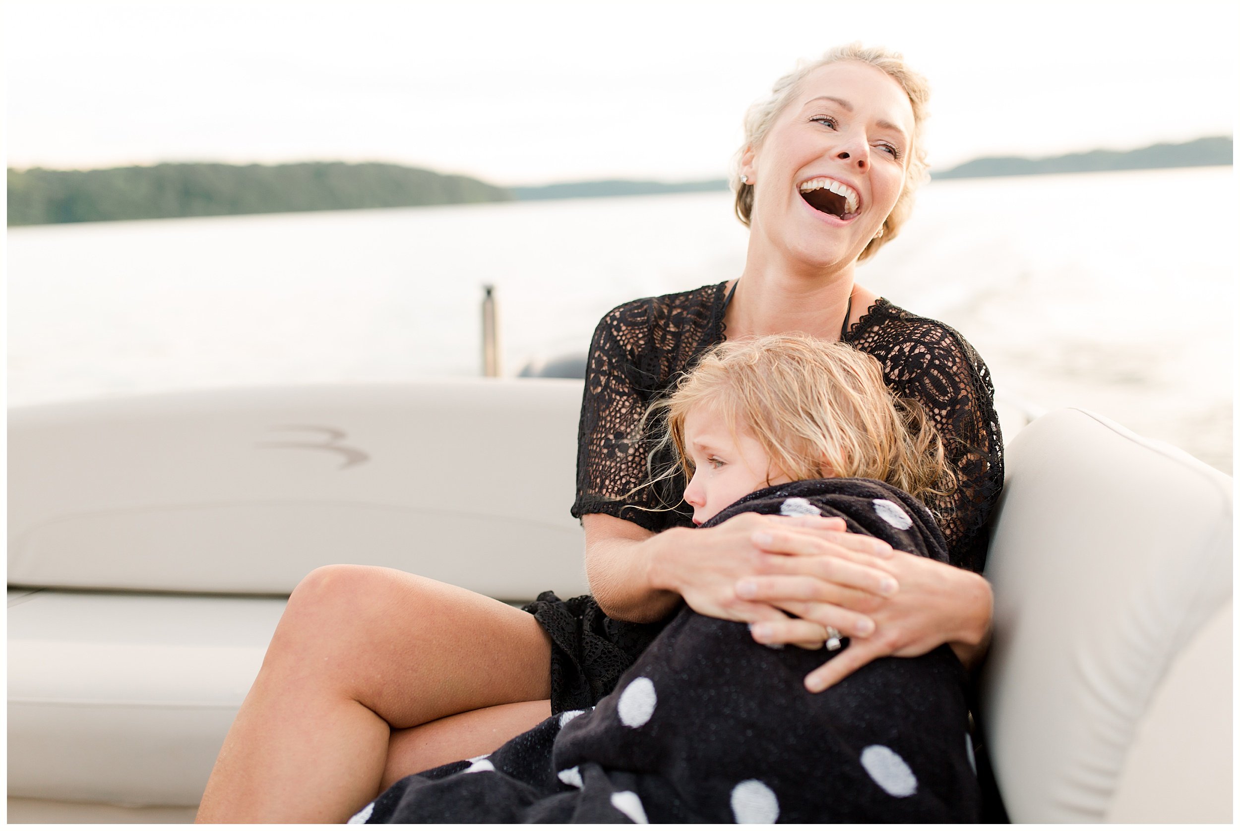  mom daughter snuggles on boat on lake lifestyle family photo session KY 