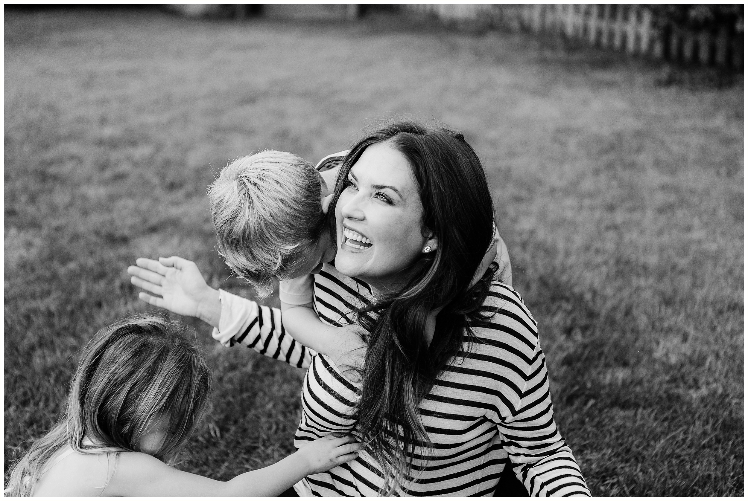  mom being tickled by children in fun family photography session in Lexington 