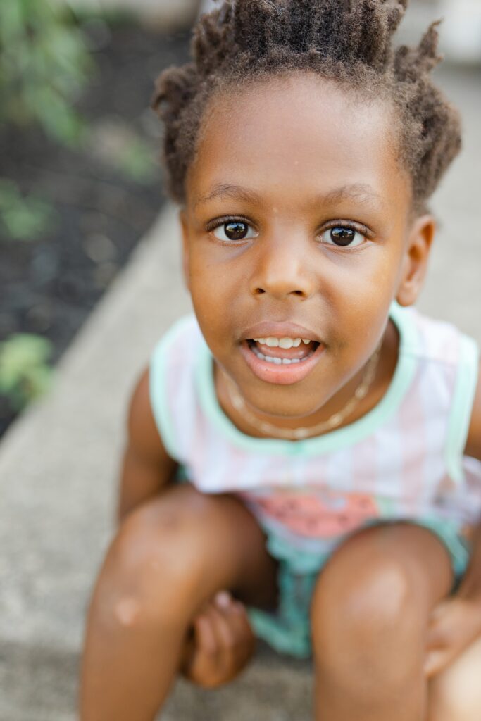A close-up image of a little girl smiling.