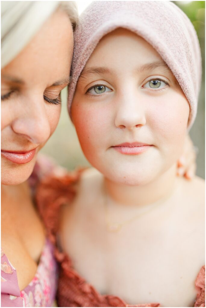 A mom and her teenage daughter share a loving embrace during their family photography session.
