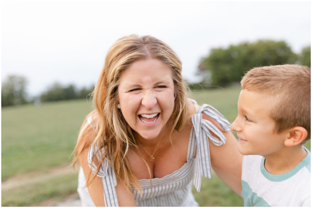 A mother laughs big with her son while enjoying their family photography session with Priscilla Baierlein Photography in Berea KY.