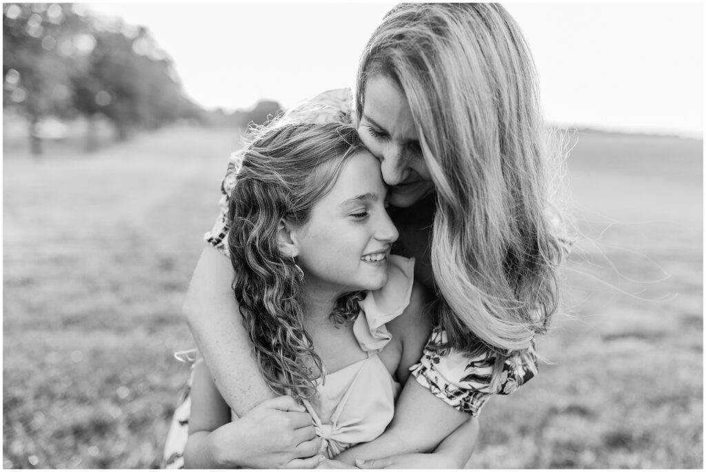 A mom holds her daughter as they laugh and she tells her how much she loves her.